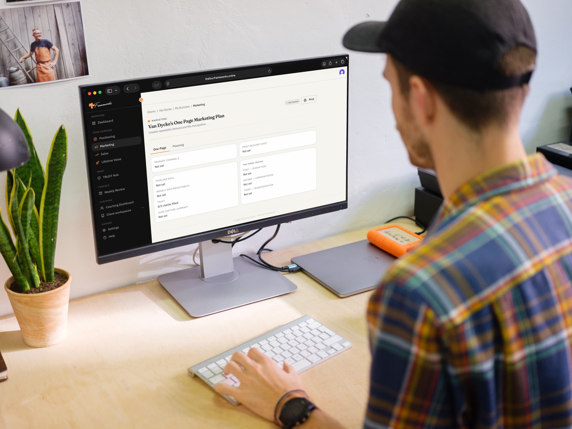 A founder working through the Four Frameworks app on a desktop monitor